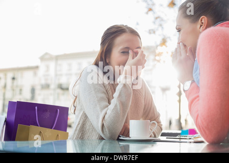 Happy women gossiping at outdoor cafe Stock Photo