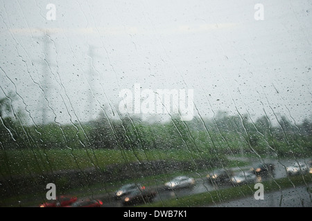 View through window of highway and traffic on a rainy day