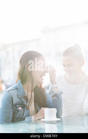 Happy women at sidewalk cafe during winter Stock Photo
