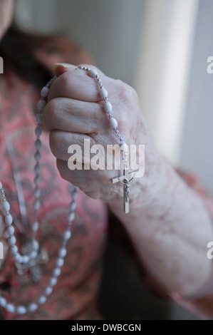 Senior woman holding rosary Stock Photo