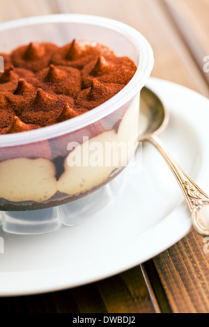 dessert tiramisu in cup on kitchen table Stock Photo