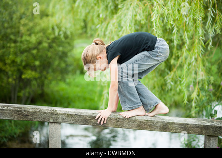 Balancing On Railing Girl balancing on railing of wooden boardwalk Stock Photo - Alamy
