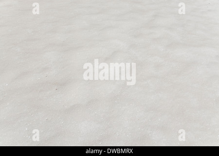Wind blown sand creating subtle little micro-dunes on a beach. Texture background. Stock Photo