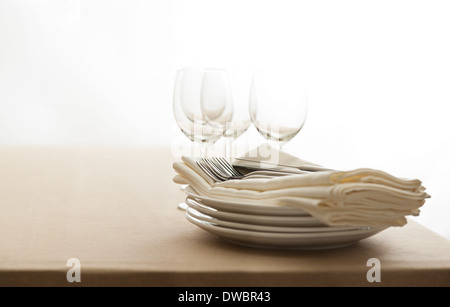 Wine glasses, cutlery, plates and napkins on a table Stock Photo