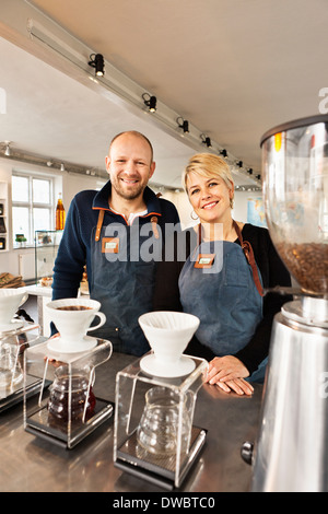 Portrait of mature couple in coffee shop kitchen Stock Photo