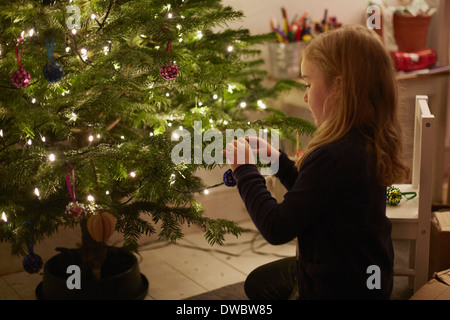 Young girl decorating christmas tree Stock Photo