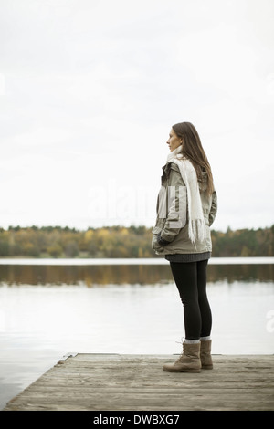 Side view of woman standing on pier Stock Photo