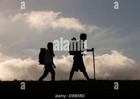 Hikers with backpack and walking stick Stock Photo