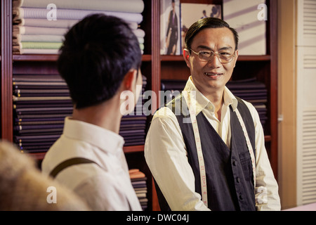 Father and son in family tailors shop Stock Photo