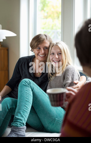 Happy three generation females spending leisure time at home Stock Photo