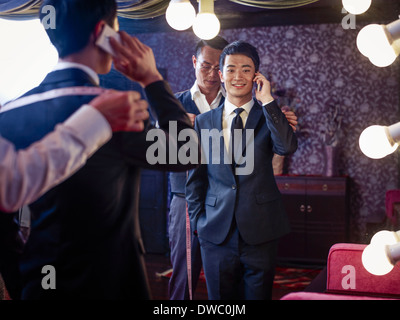 Young man trying on suit in traditional tailors shop Stock Photo