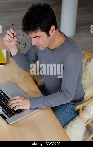 Mature businessman working an laptop at home Stock Photo