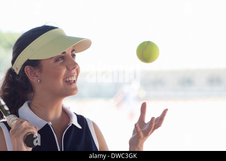 Tennis player tossing ball Stock Photo