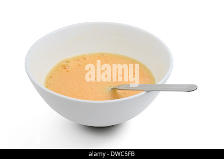 Beaten egg yolks in cup with clipping path Stock Photo