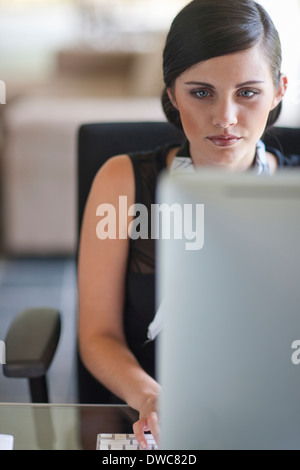 Young office worker using computer Stock Photo