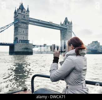 Female photographer taking photograph of Tower Bridge London, UK Stock Photo