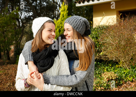 Sisters hugging in garden Stock Photo