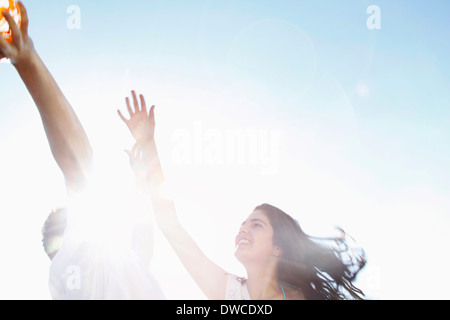 Young couple playing in sunlight, low angle view Stock Photo