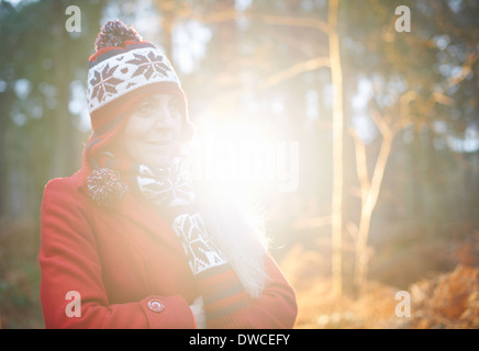 Mature woman wearing knit hat and red coat Stock Photo