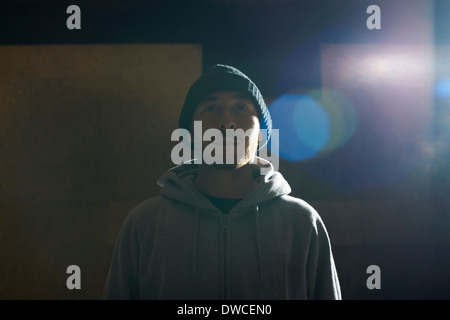 Portrait of young man wearing knit hat and hooded top Stock Photo