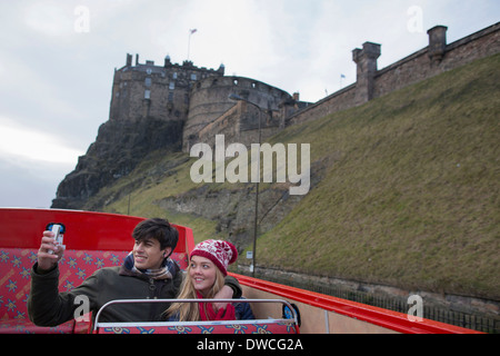 A young couple on an open-top bus tour of Edinburgh Scotland Stock Photo