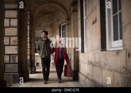 A young couple walk in the centre of Edinburgh Stock Photo