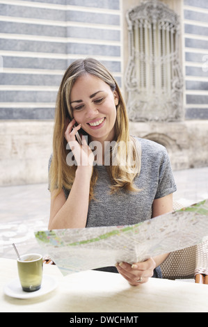 Young woman looking at map outside Museum of Ceramics, Valencia, Spain