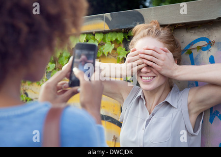 Two young women photographing with smartphone Stock Photo
