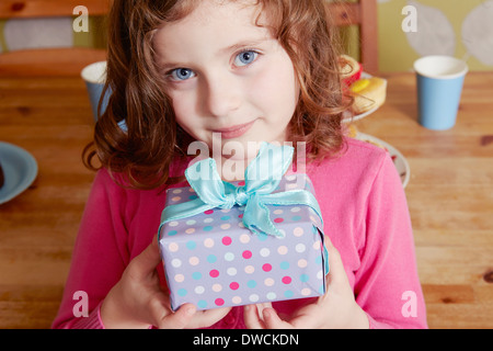 Portrait of girl holding birthday present Stock Photo