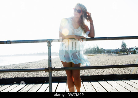 Young woman standing on pier, Melbourne, Victoria, Australia Stock Photo