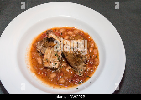 Duck confit - slow cooked duck leg slow with sausage, bacon and beans Stock Photo