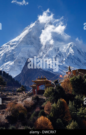 Manaslu peak looming over the new monastary in Lho, Nepal. Stock Photo