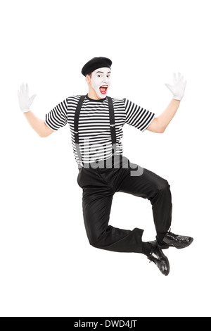 Full length portrait of mime artist jumping with joy Stock Photo