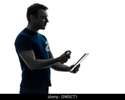 one  man cleaning dusting digital tablet in silhouette on white background Stock Photo