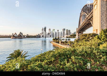 The view across Sydney harbor at dawn showing the Opera House and harbour bridge. Stock Photo