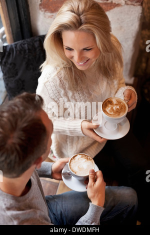 High angle view of young couple having coffee at cafe Stock Photo