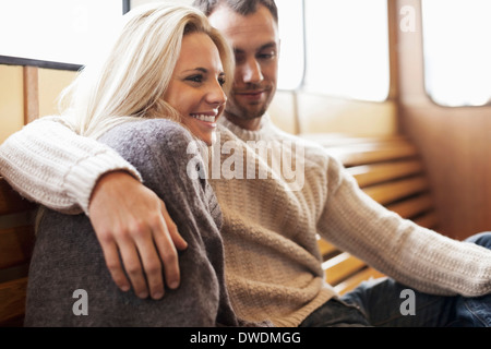 Romantic young couple sitting on ferry Stock Photo