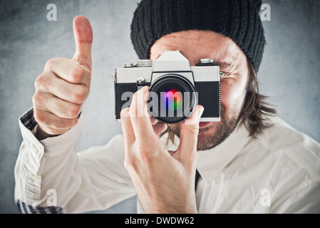 Businessman taking picture with old vintage film photo camera Stock Photo