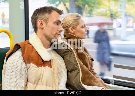 Young couple travelling in bus Stock Photo