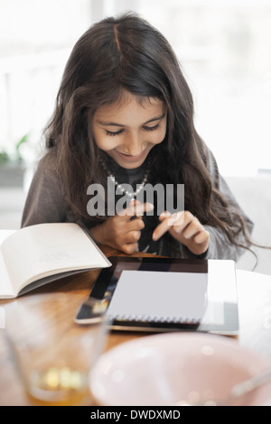 Happy girl using digital tablet at home Stock Photo