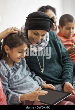 Family using digital tablet at home Stock Photo