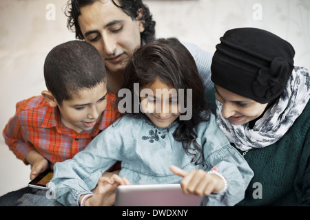 Muslim family using digital tablet together at home Stock Photo