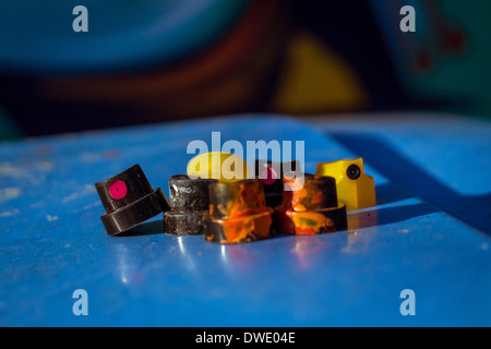 A clump of used and discarded spray can nozzles with a graffiti backdrop. Stock Photo
