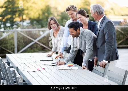 Business people working on patio Stock Photo