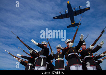 The US Marine Corps Blue Angels C-130 Hercules aircraft, affectionately known as Fat Albert, flies over the Silent Drill Platoon during air show rehearsal March 4, 2014 at Marine Corps Air Station Yuma, Arizona. Stock Photo