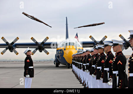 The US Marine Corps Blue Angels C-130 Hercules aircraft, affectionately known as Fat Albert, parks next to the Silent Drill Platoon during air show rehearsal March 4, 2014 at Marine Corps Air Station Yuma, Arizona. Stock Photo