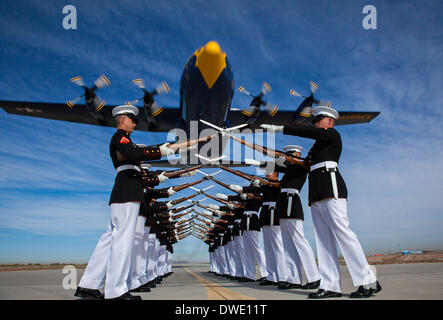 The US Marine Corps Blue Angels C-130 Hercules aircraft, affectionately known as Fat Albert, flies over the Silent Drill Platoon during air show rehearsal March 4, 2014 at Marine Corps Air Station Yuma, Arizona. Stock Photo