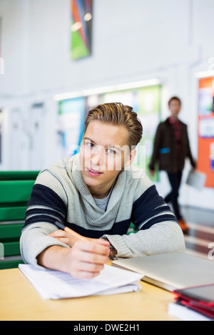 Portrait of confident university student studying in common room Stock Photo