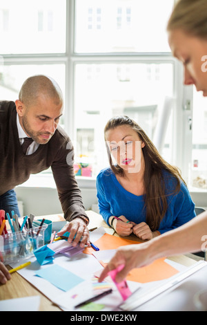 Business people working together at desk in creative office Stock Photo