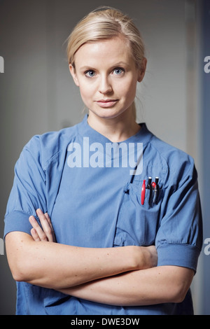 Portrait of a female nurse standing with her Arms Crossed Arms Folded ...